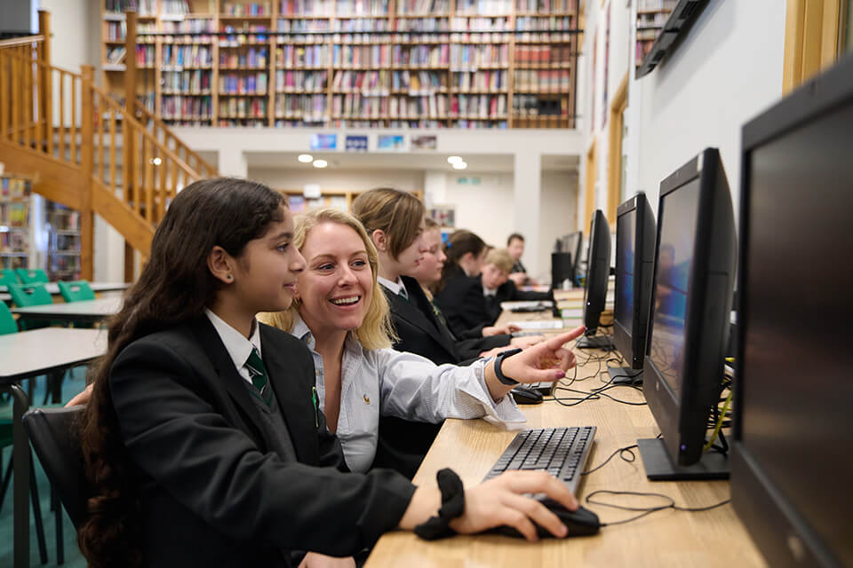 A teacher using First News with pupils in a classroom