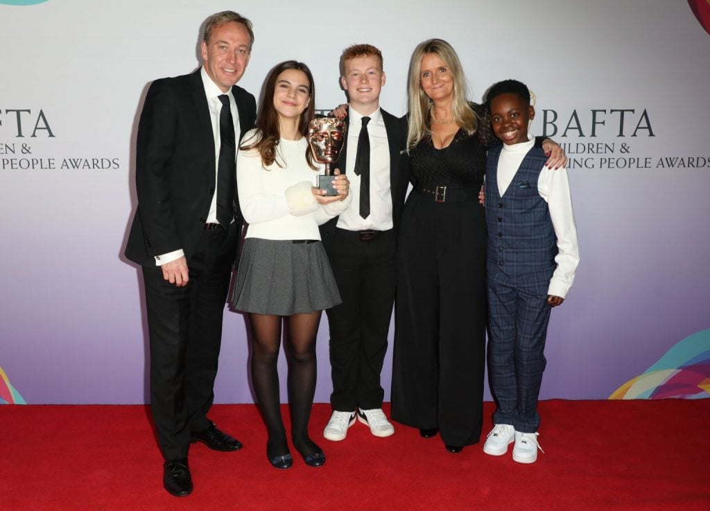 The FYI team with production company Fresh Start Media's head of production, Ian Pyke and CEO Nicky Cox MBE, also editor of First News, holding the bafta award for their work on the Ukraine war invasion special