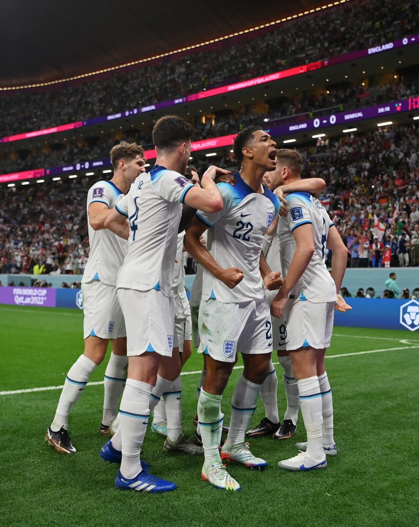 On December 4, 2022, in Al Khor, Qatar, Jude Bellingham of England celebrates Jordan Henderson's goal during the England vs. Senegal FIFA World Cup Qatar 2022 Round of 16 game at Al Bayt Stadium.