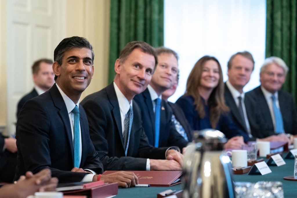 (L-R) Britain's Prime Minister Rishi Sunak, Britain's Chancellor of the Exchequer Jeremy Hunt, Britain's Secretary of State for Business, Energy and Industrial Strategy Grant Shapps, Britain's Secretary of State for Environment, Food and Rural Affairs Therese Coffey, Britain's Secretary of State for Education Gillian Keegan, Britain's Scottish Secretary Alister Jack and Britain's Minister of State for Development in the Foreign, Commonwealth and Development Office Andrew Mitchell pose for a photograph during the first cabinet meeting under the new Prime Minister, Rishi Sunak in 10 Downing Street in central London on October 26, 2022. - Sunak's largely same-look cabinet holds an inaugural meeting today before he heads to the House of Commons for his first weekly "Prime Minister's Questions", when he will battle Labour leader Keir Starmer and other opposition lawmakers. (Photo by Stefan Rousseau / POOL / AFP) (Photo by STEFAN ROUSSEAU/POOL/AFP via Getty Images)