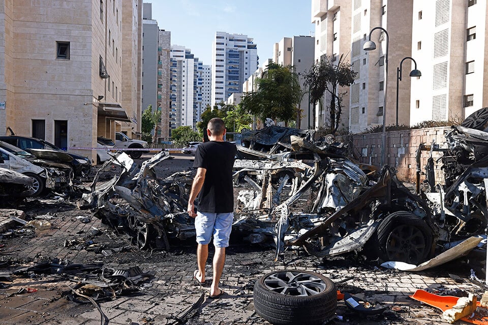 A boy walking through the rubble of destroyed buildings in Israel