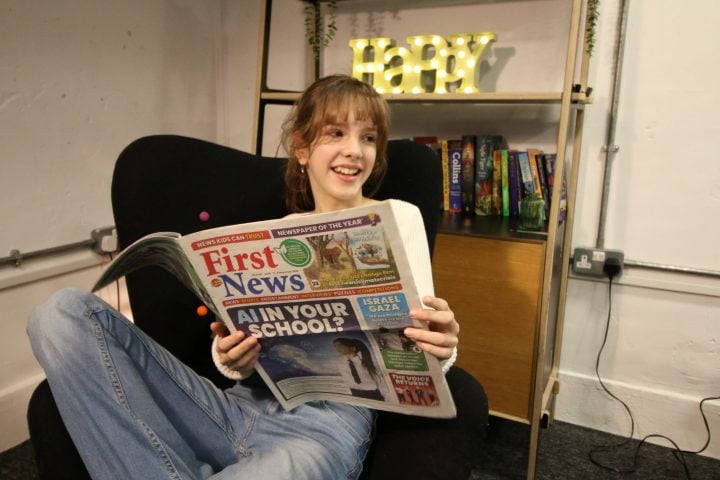 Girl reading First News